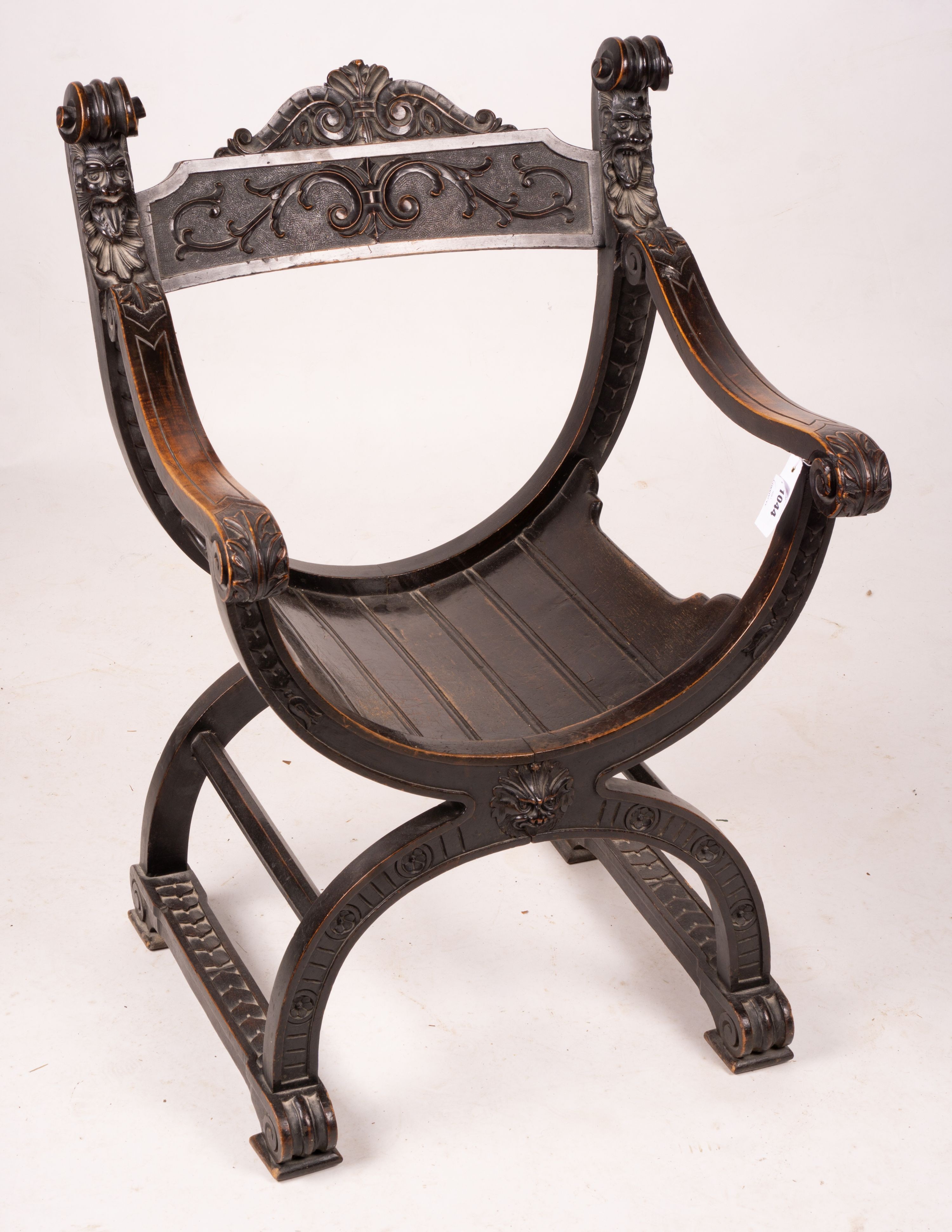 An ebonised Sagrada style elbow chair